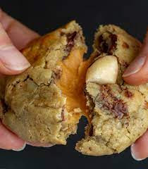 caramel stuffed cookie in a hand